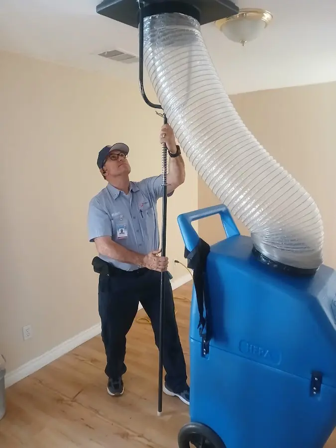 Furnace Tune-Up technician using HEPA equipment in Corsicana
